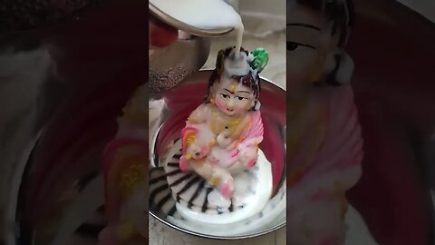 Lord Krishna bathing with milk