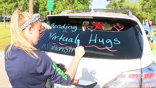 Pasco County teachers drive by several neighborhoods with messages on their cars to students