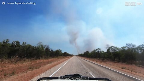 Driver captures dust devil forming on the road