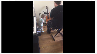 Baby girl rocks out to dad's guitar performance