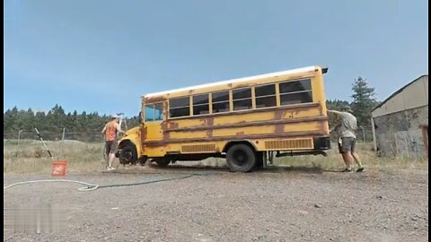 Three men, scrapped school bus, converted into a caravan.