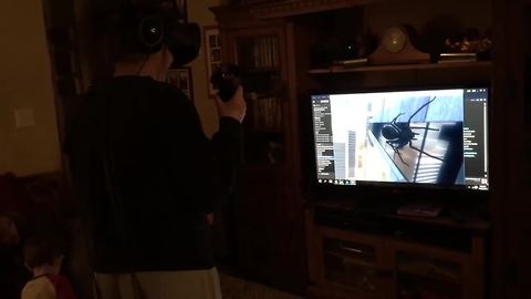 Girl tries out VR game, crashes into TV stand