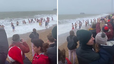 Wind, rain and waves for the annual Christmas Day swim on Brighton Beach
