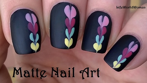 Matte black nail art idea with heart design