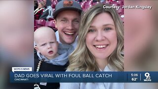 Reds fan makes impressive catch while bottle-feeding baby