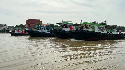 Tugboats Pulling a long Barge at Koh Kret Island in Thailand
