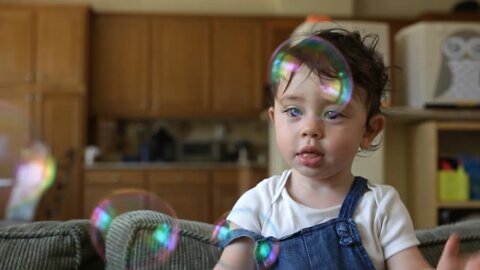 Toddler Playing with Bubble Wand Fun