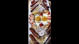 French Toast with Fried Eggs, Sausage and Fruit