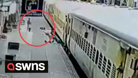 Security personnel save woman who fell between the doors of a train in Ujjain, India