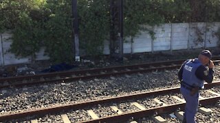 SOUTH AFRICA - Cape Town - The corpse of a young male lay alongside the train track in Southfield. (Video) (dhn)