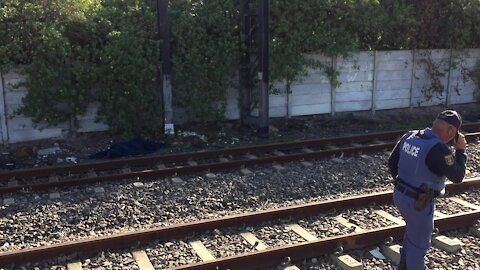 SOUTH AFRICA - Cape Town - The corpse of a young male lay alongside the train track in Southfield. (Video) (dhn)