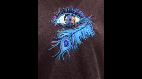 Embroidering of an eyeball and peacock feather