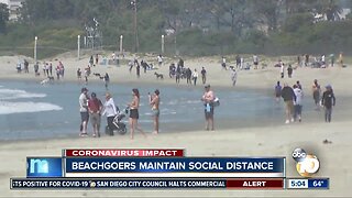 Visitors at still-open beaches maintain their social distance