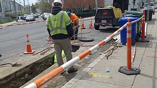 contractors digging a trench for Verizon connecting the manholes