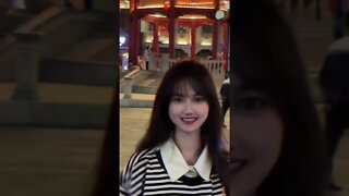 Pretty Chinese Girl Visits A Pagoda At Night
