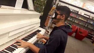 Un jeune homme joue du piano les yeux bandés