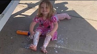 Little girl applies way too much sunscreen