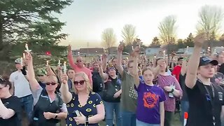 Candles are raised in Cameron, Wisconsin as the fallen officers’ families stand...