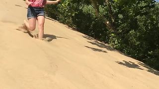 Girl Runs Down Sandy Hill But Then Falls At The End