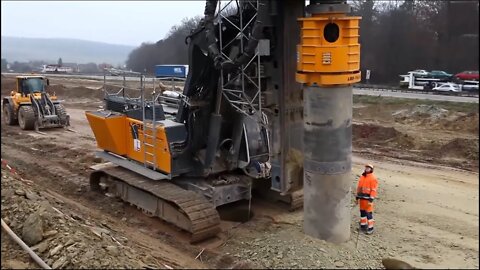 The large-scale Liebherr LB28 pile driver works very aggressively on the construction site!