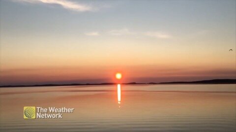 Serene sunset over still waters of Birchy Bay