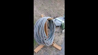 Garden hose holders and filled potato bed