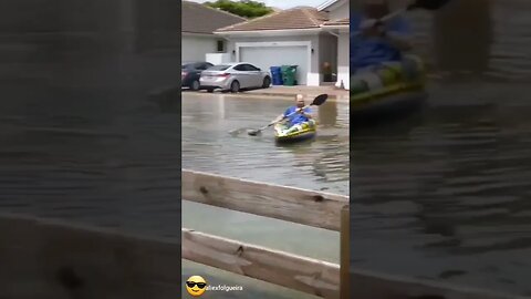 dude kayaking in maimi flooded streets