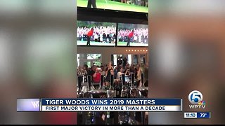 Fans celebrate Tiger Woods' victory Sunday at his Jupiter restaurant