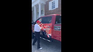 President Donald Trump signs a supporter's truck.