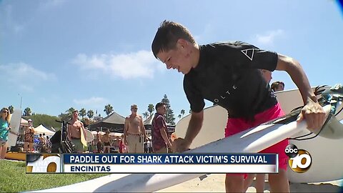 Community paddles out for boy who survived 2018 Shark attack
