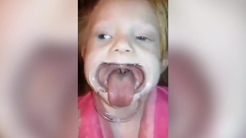Tot Girl Sticks Out Her Tongue While Playing Speak Out