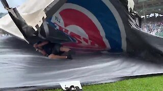 Guy gets caught underneath tarp during Cubs game