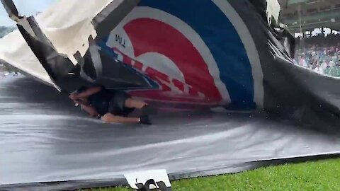 Guy gets caught underneath tarp during Cubs game