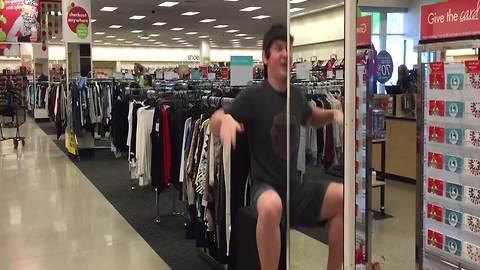 Teen Boy Dances In Front Of A Department Store Mirror