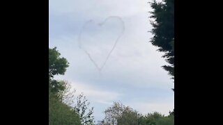 Plane paints love hearts in the sky