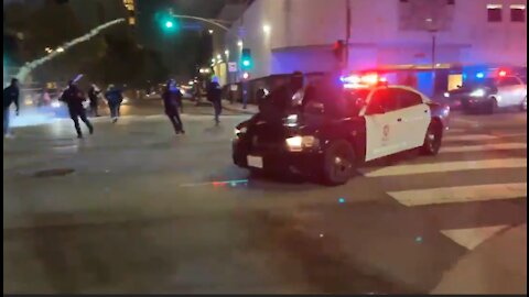 Antifa Riot in Los Angeles Rioters Jump on a Police Vehicle to Attack