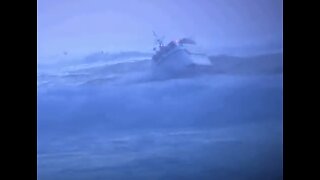 Small fishing vessel coming in harbor in Heavy Seas.