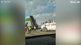 Truck stuck after colliding with overhead highway signs