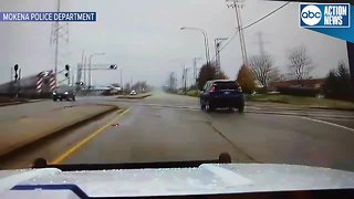 Dash cam shows police officer swerve off the road to avoid being hit by speeding train