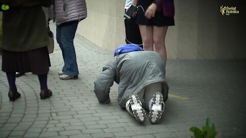 Elderly woman in tears kisses feet of angry LGBT activist, then they make sign of Cross together