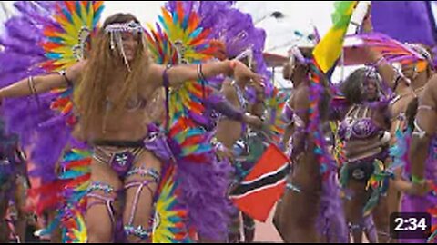 Revellers jump and wave at the 2024 Toronto Caribbean Carnival