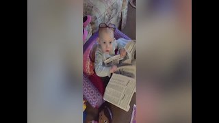 Adorable Baby Pretends to Read Newspaper