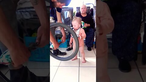 Cute Baby Playing With Bicycle Tyre