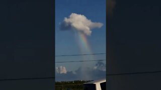 Cloud pouring out a rainbow in Falmouth, Jamaica.