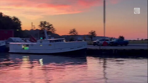 The sunrise bathes a marina area in Port Stanley, Ontario in hues of pink