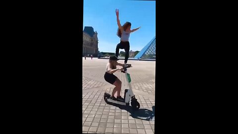 2 chicks trying gymnastics on a scooter, doesn't end well