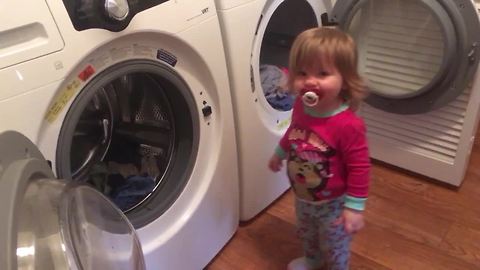 Helpful toddler loves to do the laundry