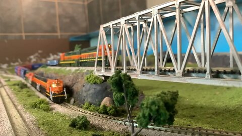 N Scale locals meet under over bridge