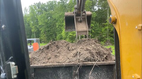 Relocating topsoil piles to break down organic material