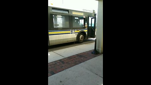 Suffolk county transit Orion bus departing shopping center in Babylon New york